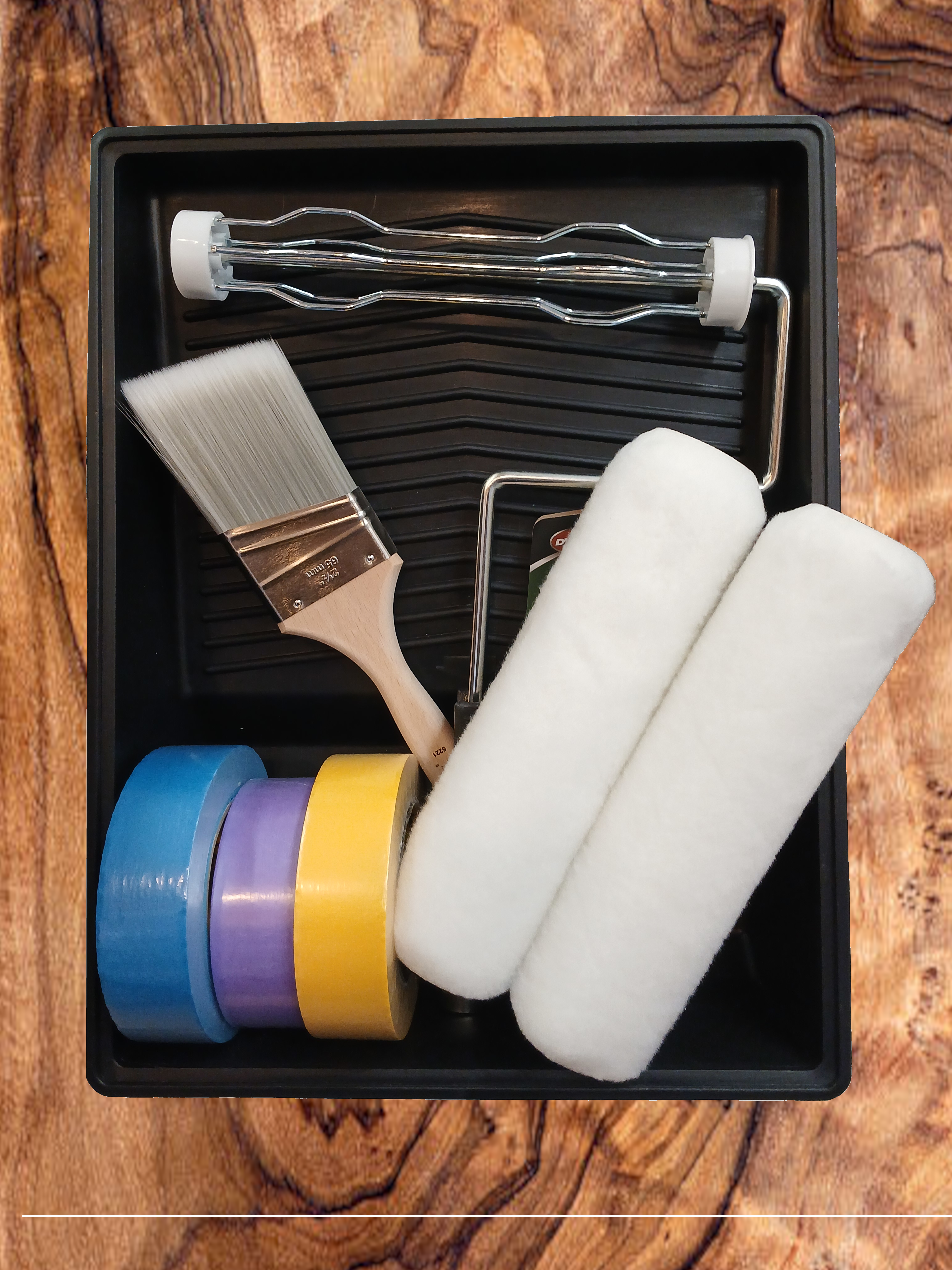 Top down view of three paint buckets with grey red and blue paint in them